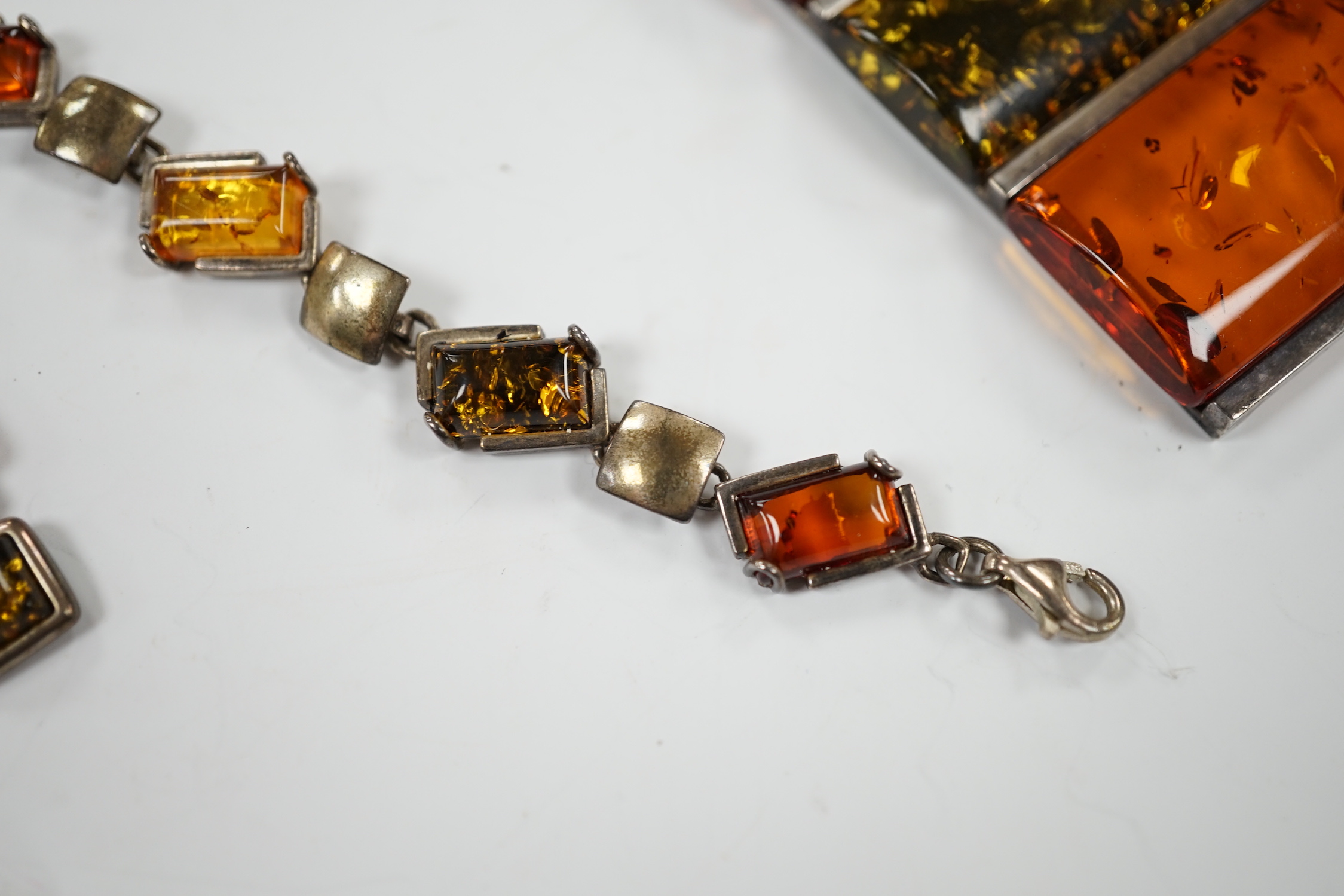 A modern 925 and three stone amber set pendant necklace, 42cm, together with a similar bracelet and pair of drop earrings.